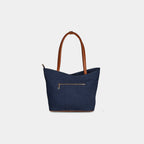 Back view of blue geometric denim bag with zipper pocket