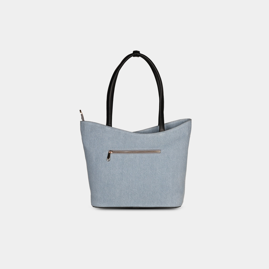 Back view of geometric light blue denim bag with secure zipper pocket