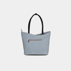 Back view of geometric light blue denim bag with secure zipper pocket