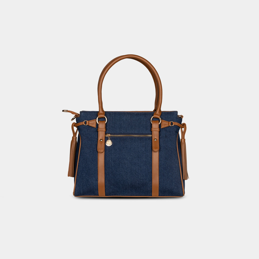 Back view of deep navy denim handbag with secure zipper pocket and tan leather detailing