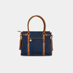 Back view of deep navy denim handbag with secure zipper pocket and tan leather detailing