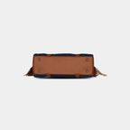 Bottom view of deep navy Tassel Denim Handbag with four protective gold metal studs