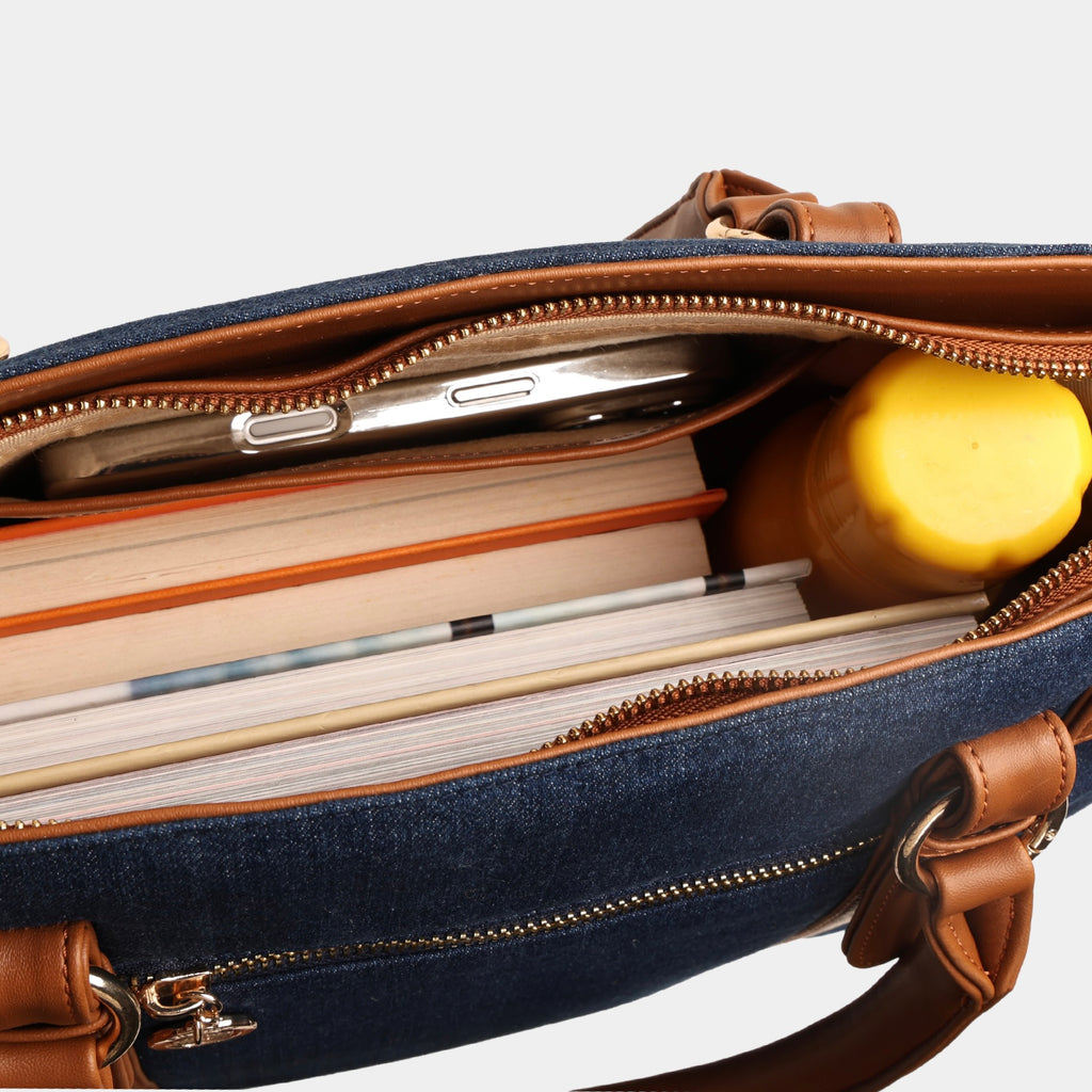 Deep navy structured denim handbag showing storage capacity with books and daily essentials inside