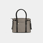 Back view of light grey denim handbag featuring secure zipper pocket
