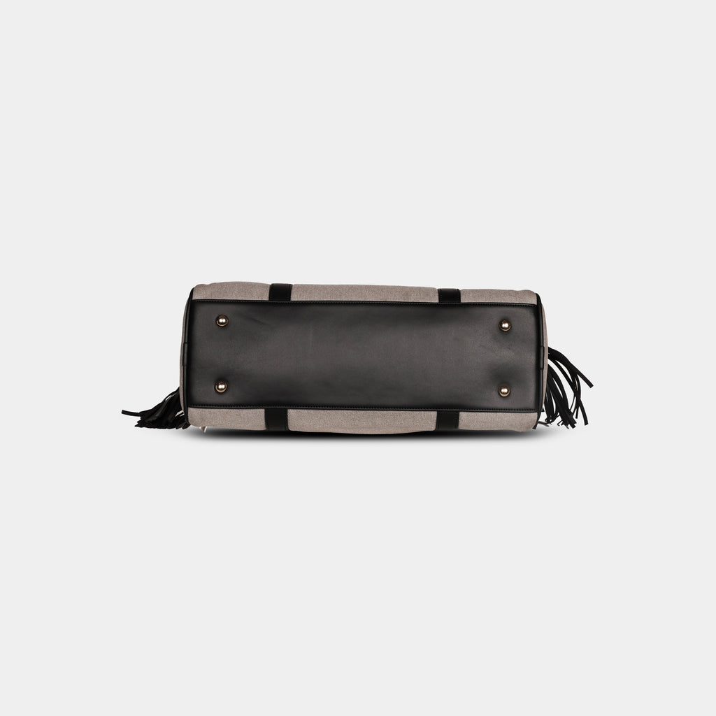 Bottom base of light grey denim handbag with four protective metal feet
