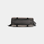 Bottom base of light grey denim handbag with four protective metal feet