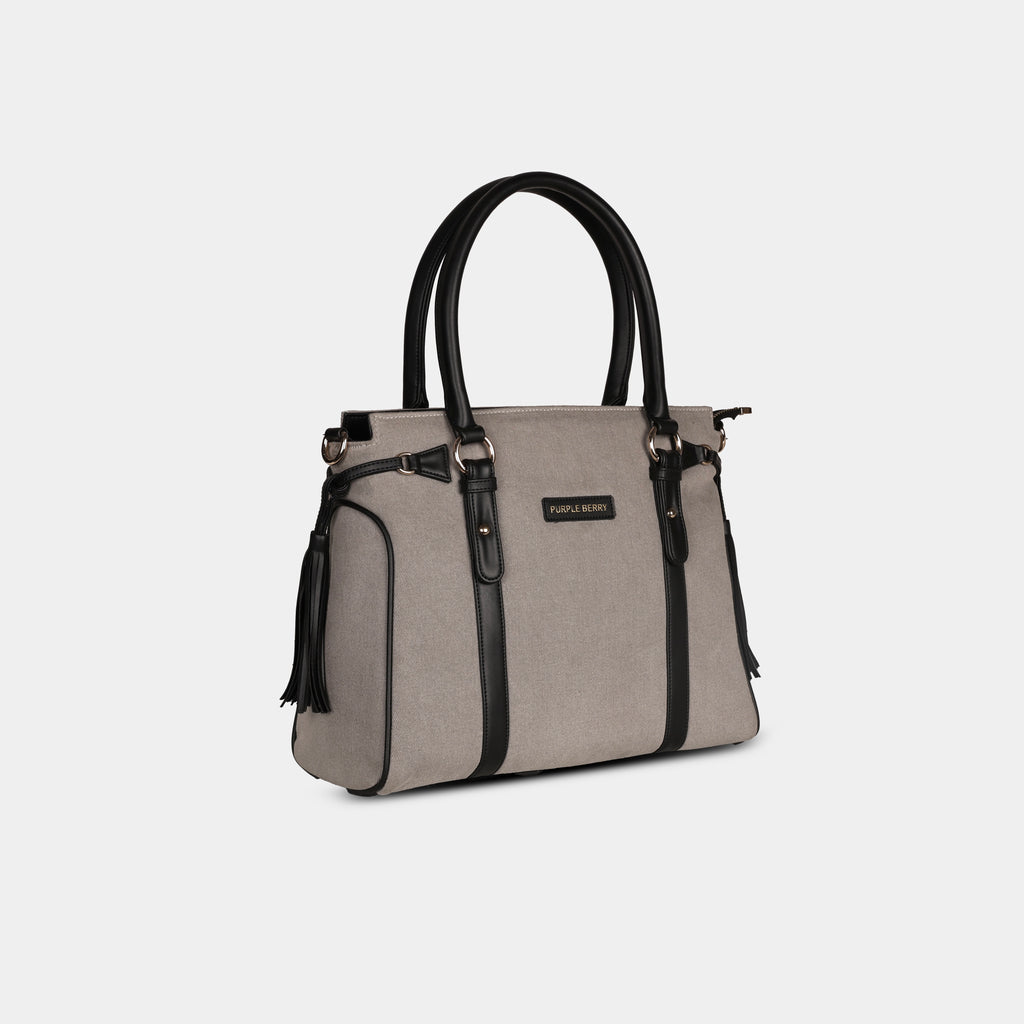 Side profile of light grey Tassel Denim Handbag with structured body and decorative tassels