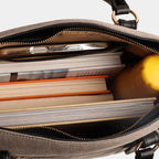 Light grey denim handbag displaying spacious storage with books and essentials inside