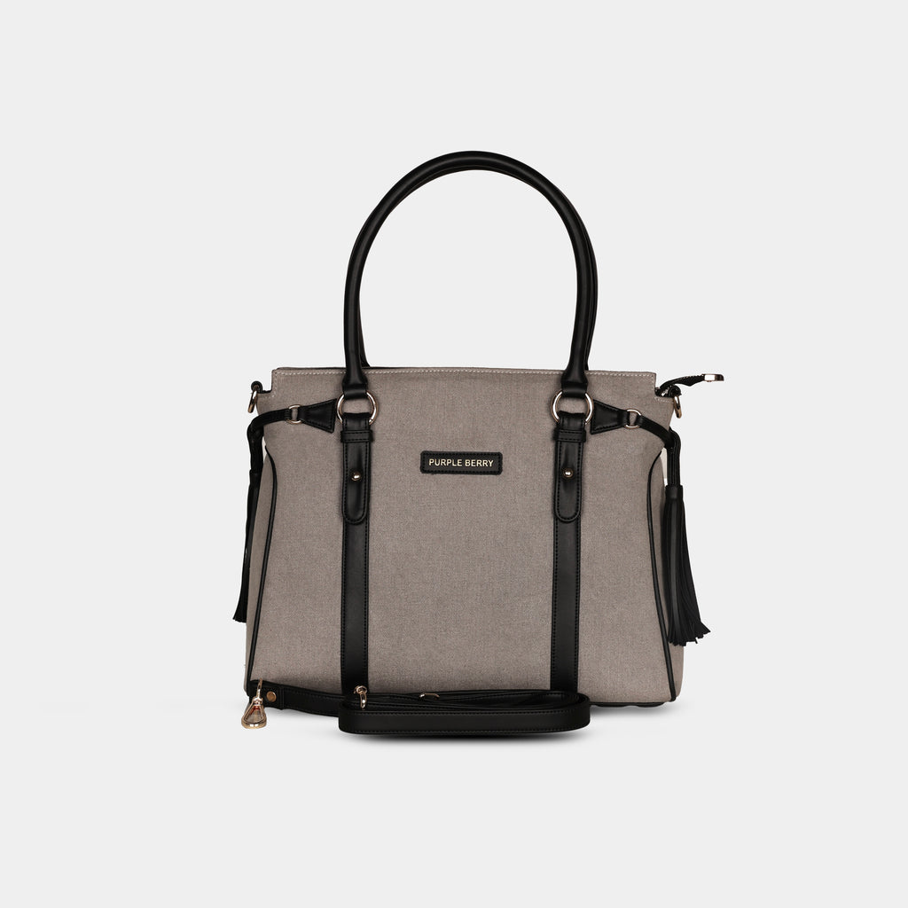 Light grey denim handbag with adjustable detachable shoulder strap and leather trims