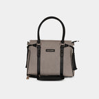 Light grey denim handbag with adjustable detachable shoulder strap and leather trims