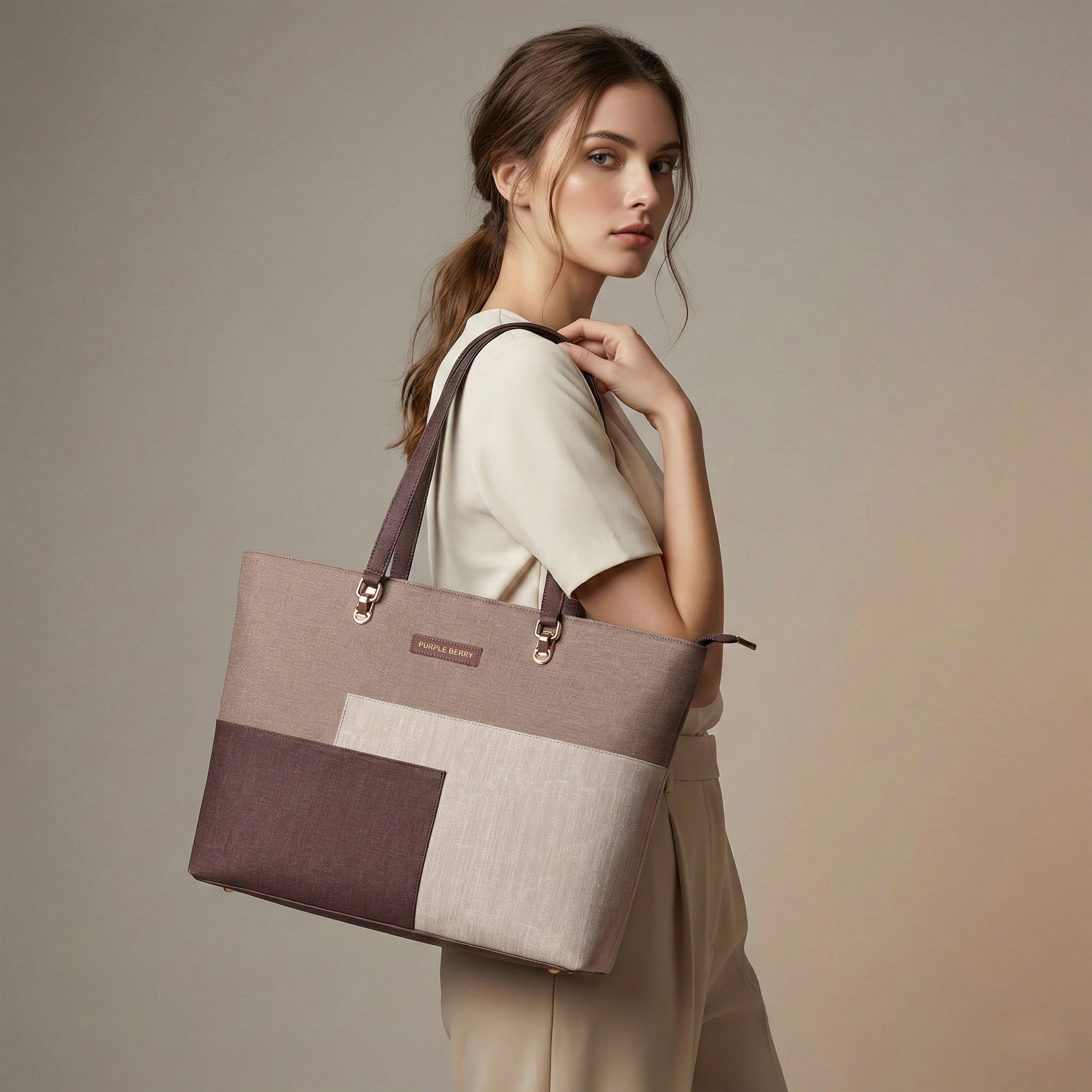 Woman holding a terra tote bag against a neutral background